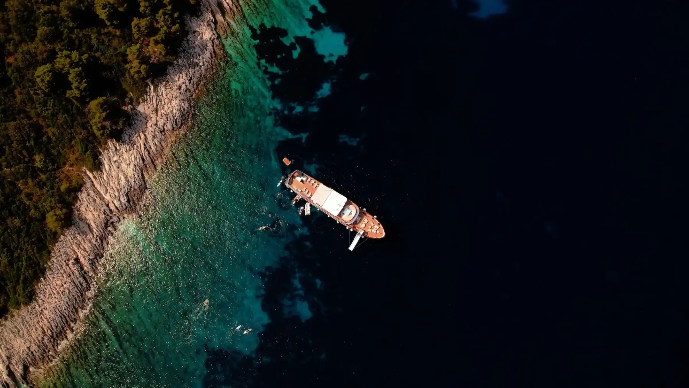 Aerial view of a small cruise ship in turquoise Adriatic water