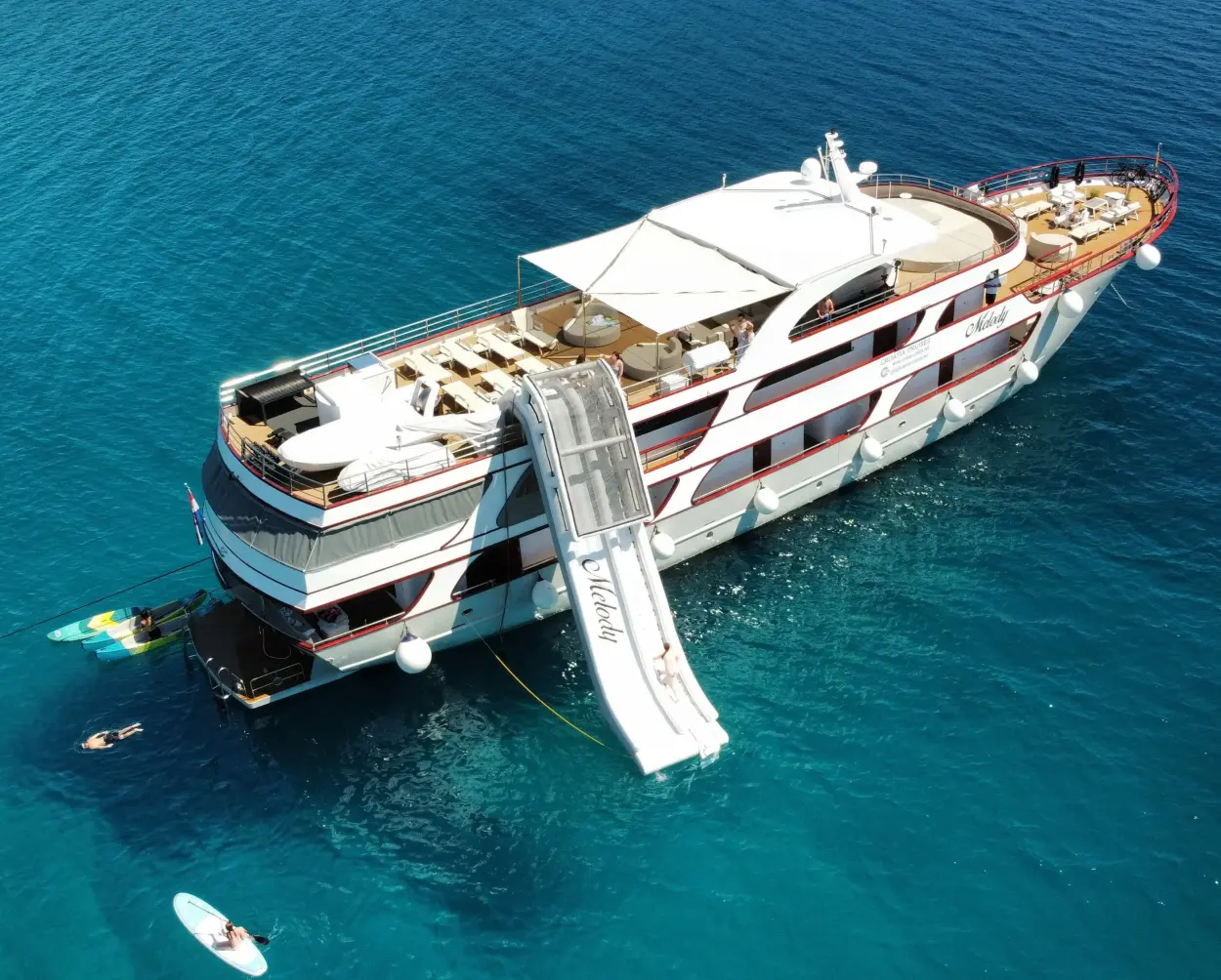 MS Melody anchored in turquoise water with a water slide