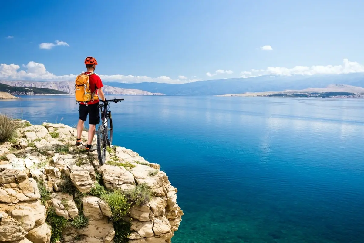 bicyclist on the rock next to the sea level, Croatia